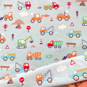 Cotone con Certificazione Oeko-Tex con stampa ruspe colorate su base azzurra