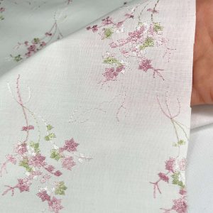 Ricamato fiorellini rosa su base cotone