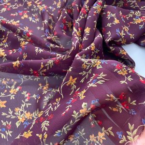 Georgette di viscosa bordeaux a fiorellini colorati ocra e rossi